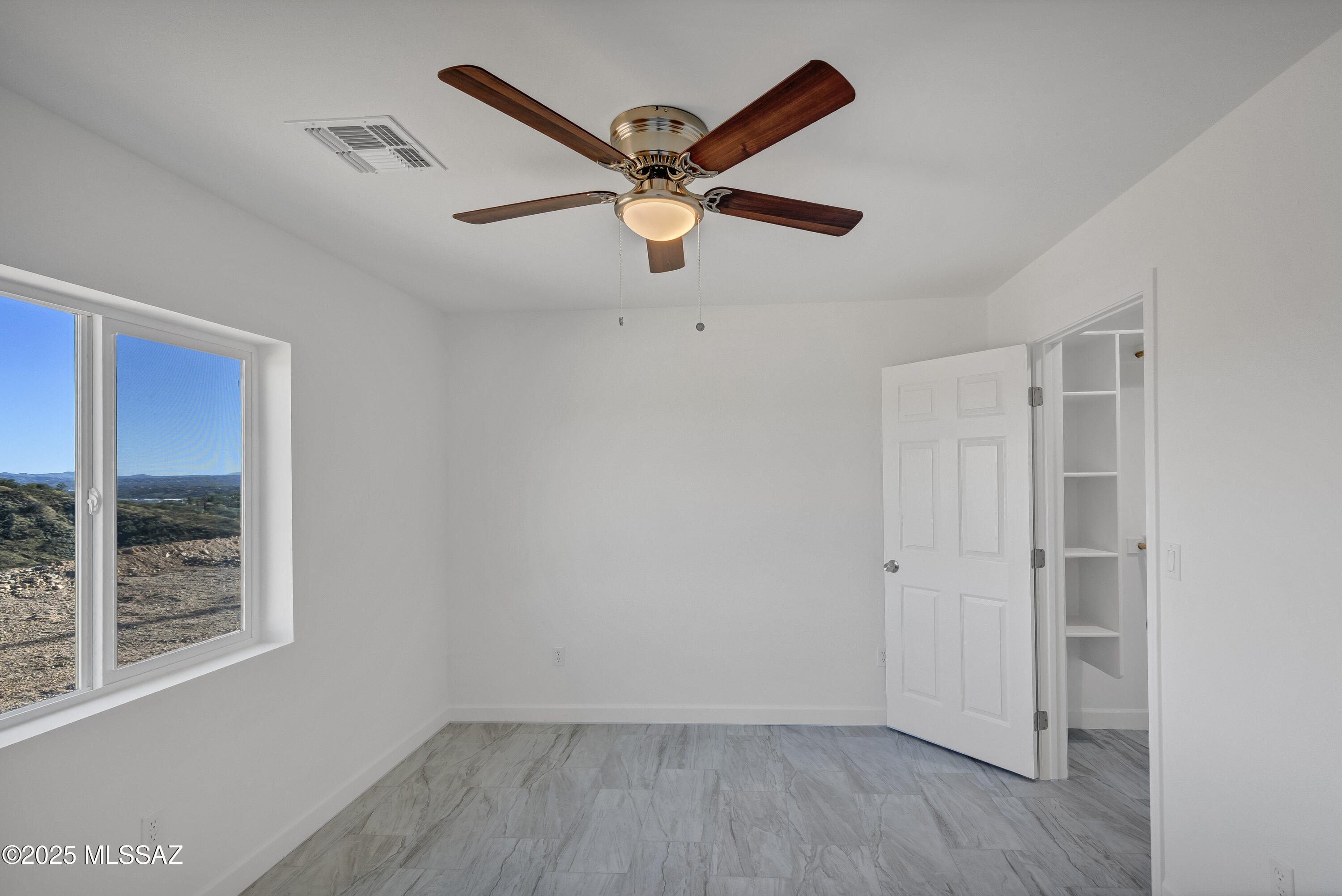329 Camino Magnifico Rio Rico, AZ 85648 - Photo 28 of 47 a view of empty room with wooden floor and fan