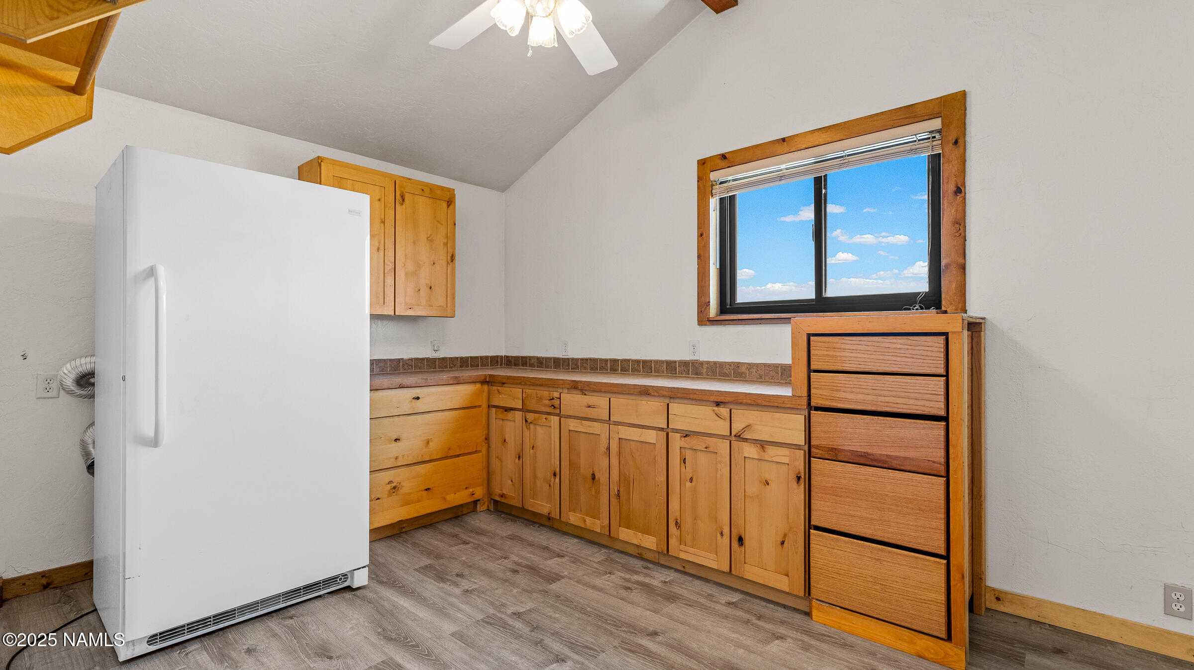 10350 Ghost Rider Trail Flagstaff, AZ 86004 - Photo 19 of 39 a kitchen with granite countertop white cabinets and white appliances