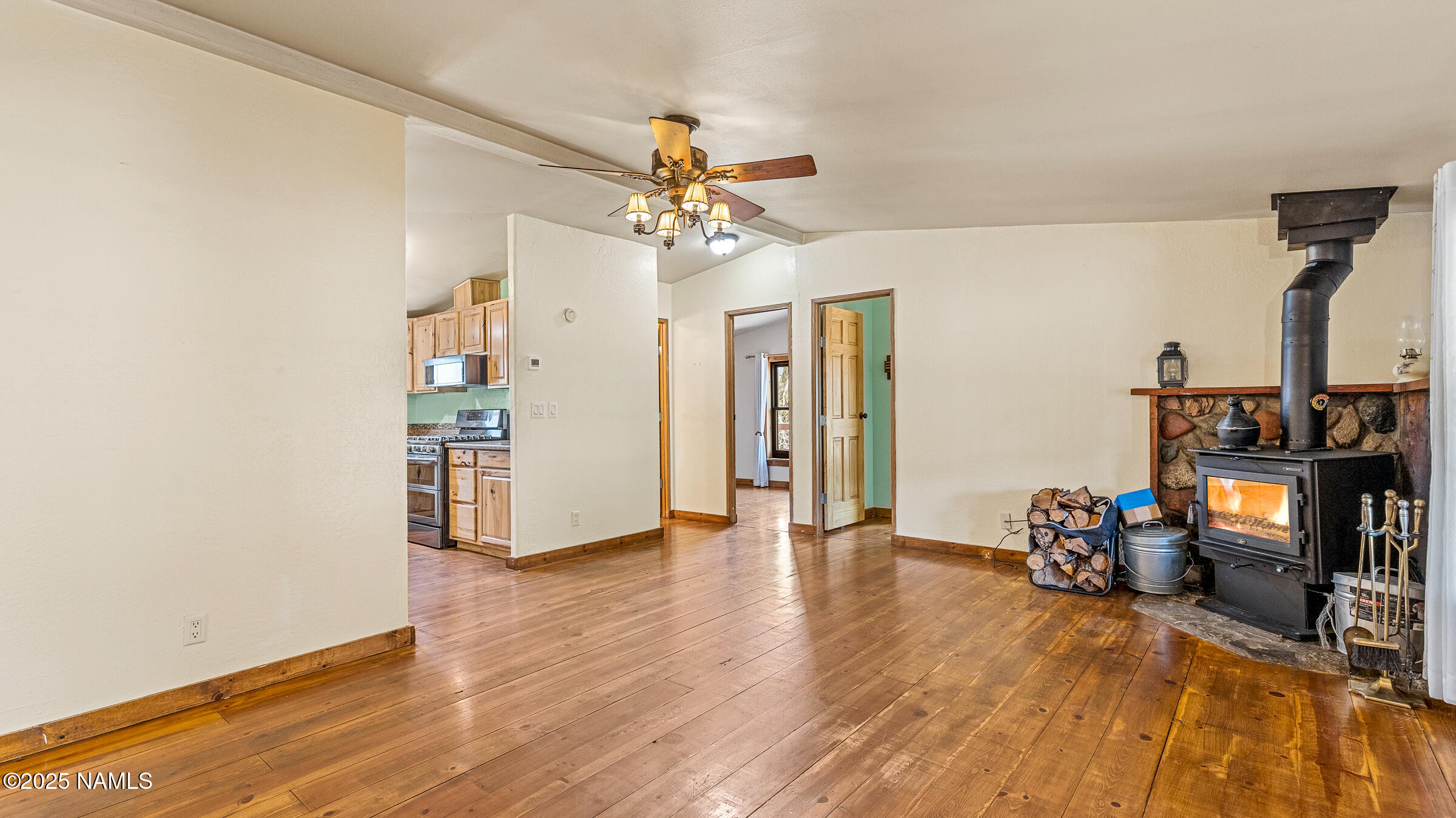 10350 Ghost Rider Trail Flagstaff, AZ 86004 - Photo 6 of 39 a view of a room with wooden floor and ceiling fan