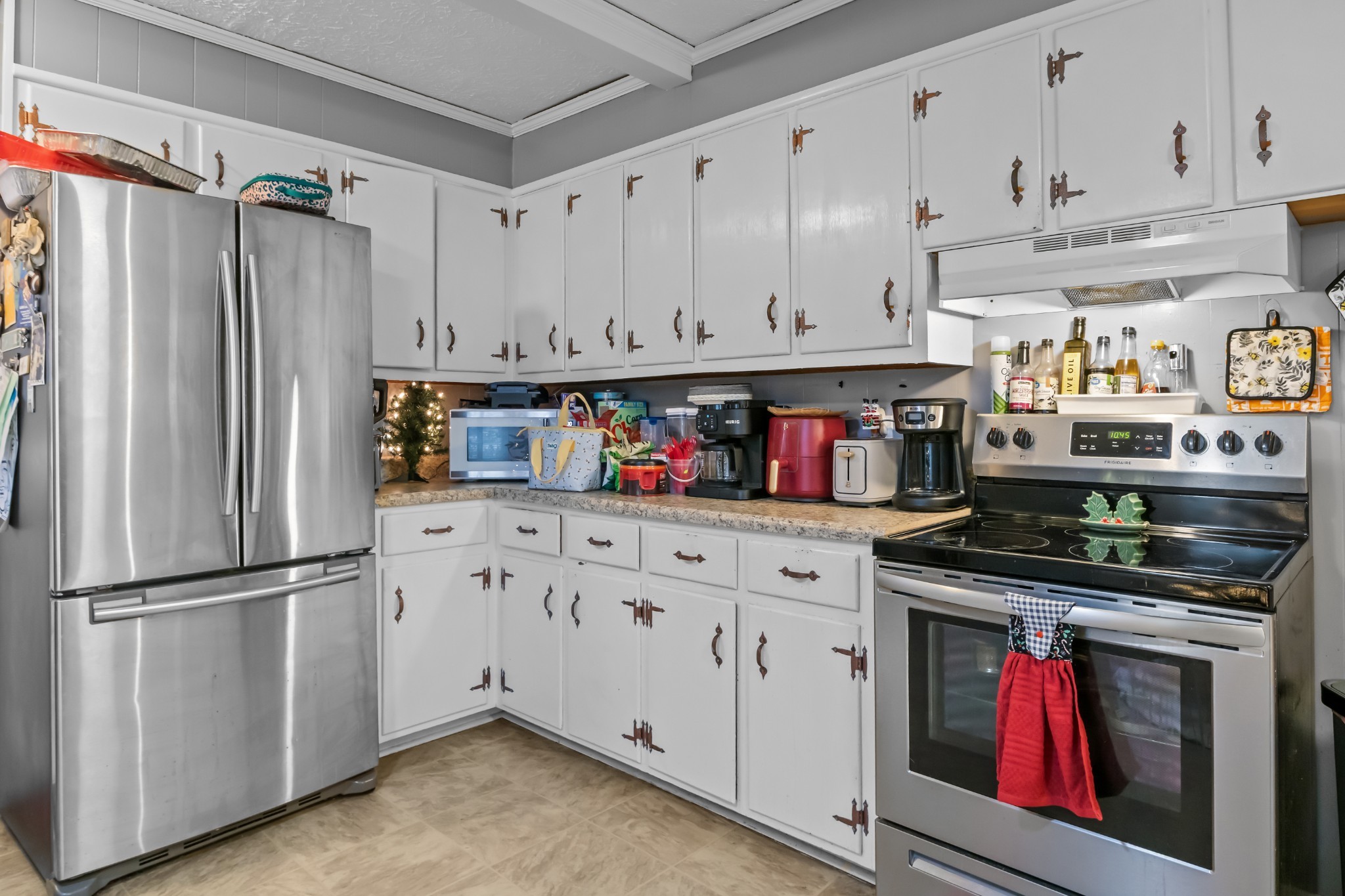 58 Florence Street McEwen, TN 37101 - Photo 10 of 20 a kitchen with stainless steel appliances granite countertop a refrigerator and a stove top oven