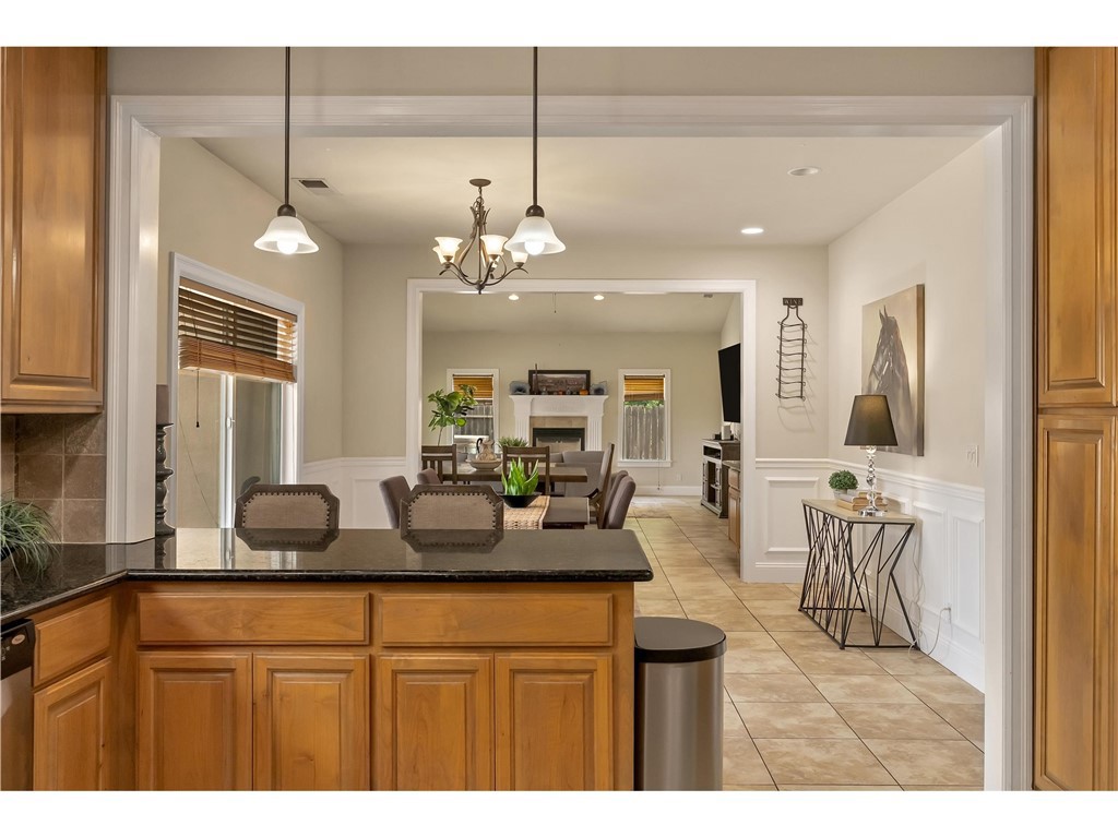 39 Redeemers Loop Chico, CA 95973 - Photo 25 of 55 a dining hall with stainless steel appliances kitchen island granite countertop a table and chairs in it