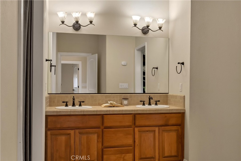 39 Redeemers Loop Chico, CA 95973 - Photo 31 of 55 a bathroom with a double vanity sink and a mirror
