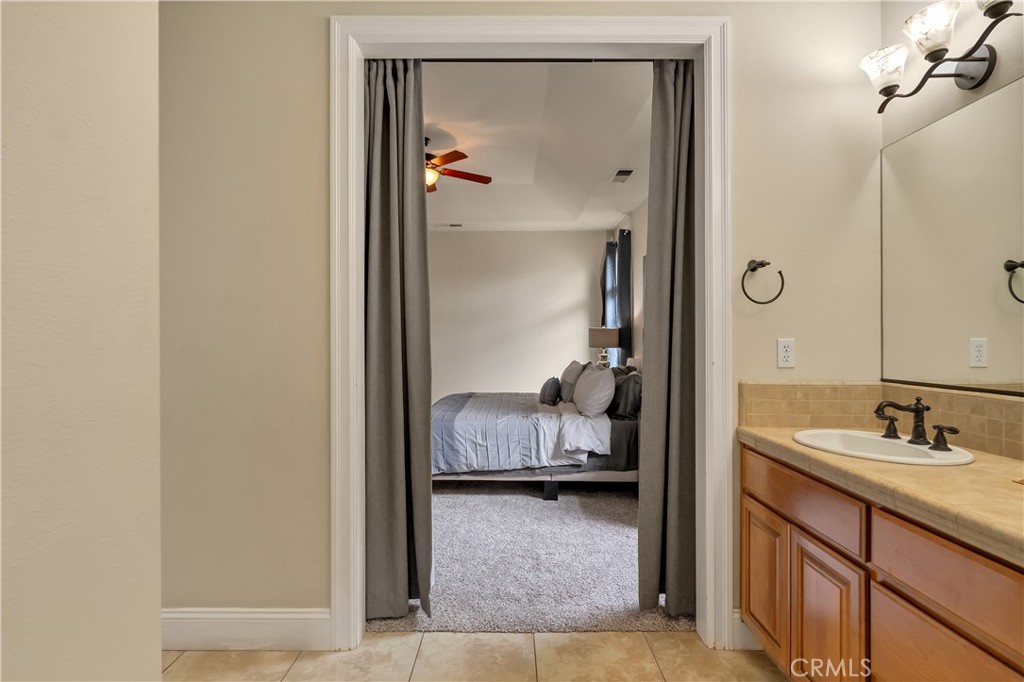 39 Redeemers Loop Chico, CA 95973 - Photo 32 of 55 a en suite bathroom with a granite countertop sink and a mirror