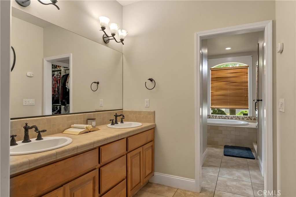39 Redeemers Loop Chico, CA 95973 - Photo 33 of 55 a bathroom with a sink and a mirror