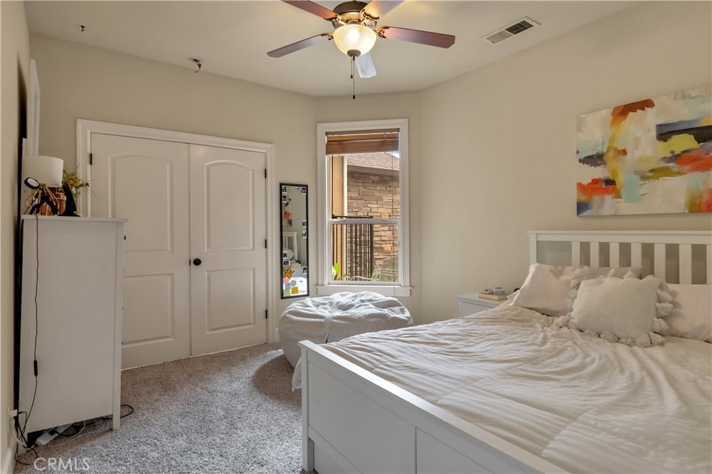 39 Redeemers Loop Chico, CA 95973 - Photo 38 of 55 a bedroom with a bed and a chandelier