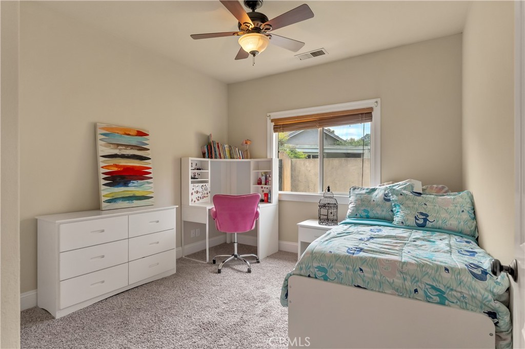 39 Redeemers Loop Chico, CA 95973 - Photo 40 of 55 a bedroom with a bed a desk and chair with window