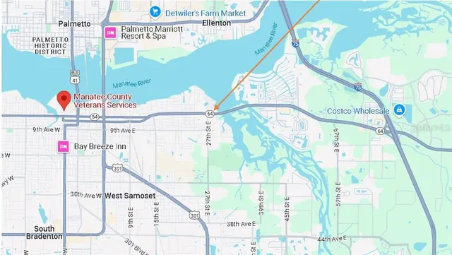 a front view of a house with a garden and trees