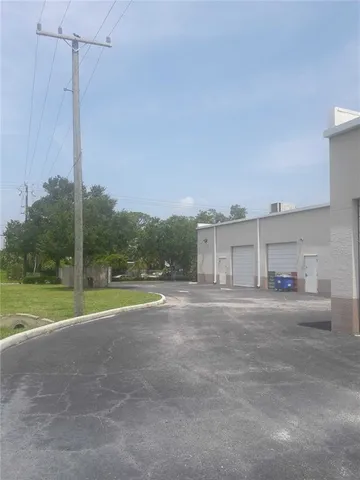 a view of a big room with a big yard and large trees