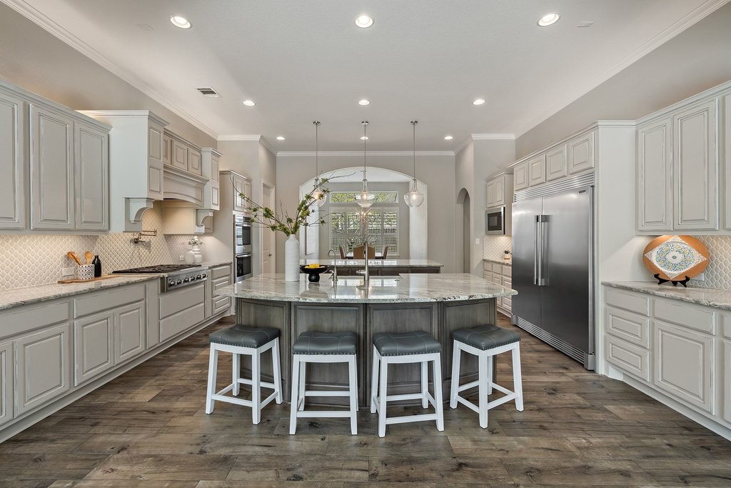 108 Berry Cove Georgetown, TX 78628 - Photo 13 of 39 a kitchen with a sink and chairs