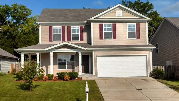 a front view of a house with garden