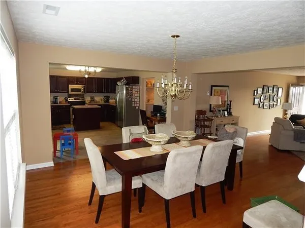 a view of a dining room with furniture wooden floor and chandelier
