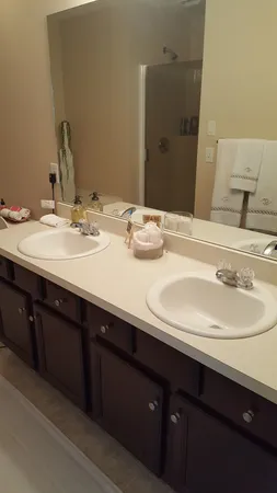 a bathroom with a double vanity sink and a mirror