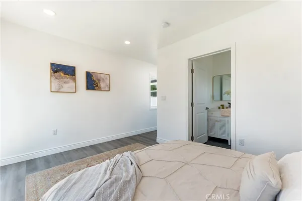 a bedroom with a bed and wall painting