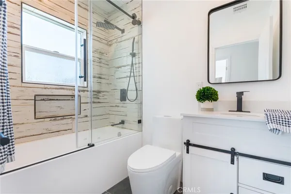 a bathroom with a toilet a sink and a mirror