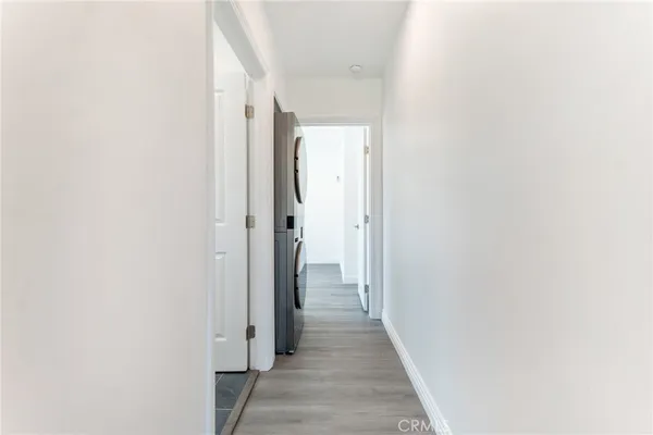 a view of a hallway with wooden shelves
