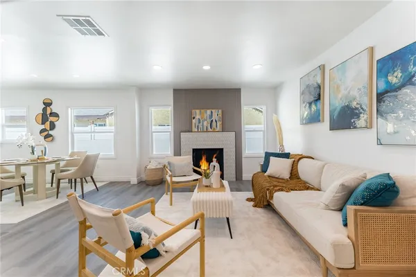 a living room with furniture a fireplace and a table