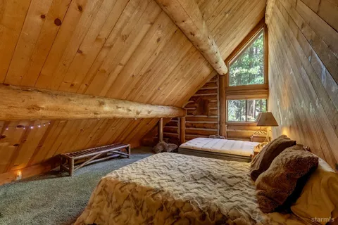 a bed sitting in a bedroom next to a window