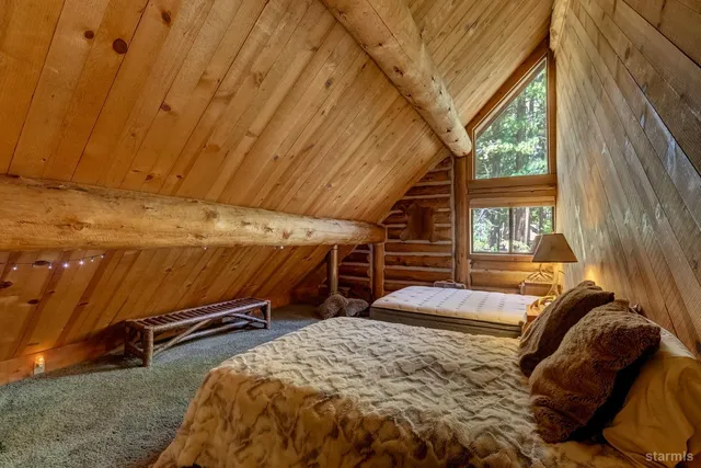 a bed sitting in a bedroom next to a window