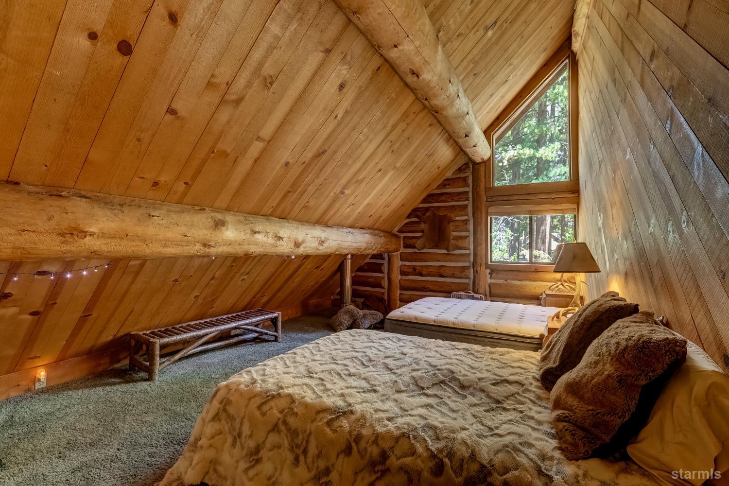 3140 Sacramento Avenue South Lake Tahoe, CA 96150 - Photo 12 of 30 a bed sitting in a bedroom next to a window