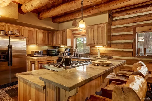 a kitchen with a stove a sink and a refrigerator