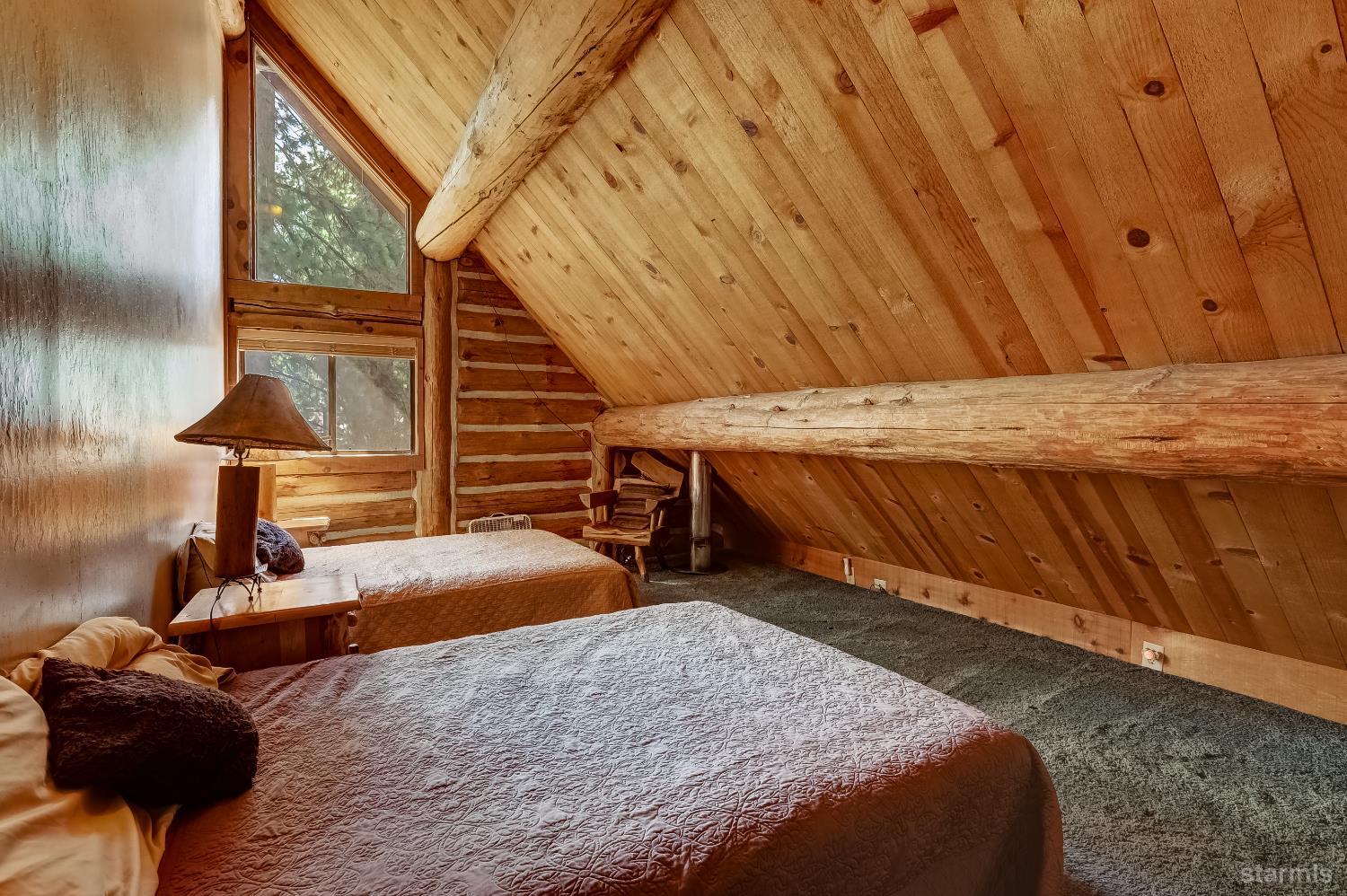 3140 Sacramento Avenue South Lake Tahoe, CA 96150 - Photo 27 of 30 a bedroom with a bed and wooden floor