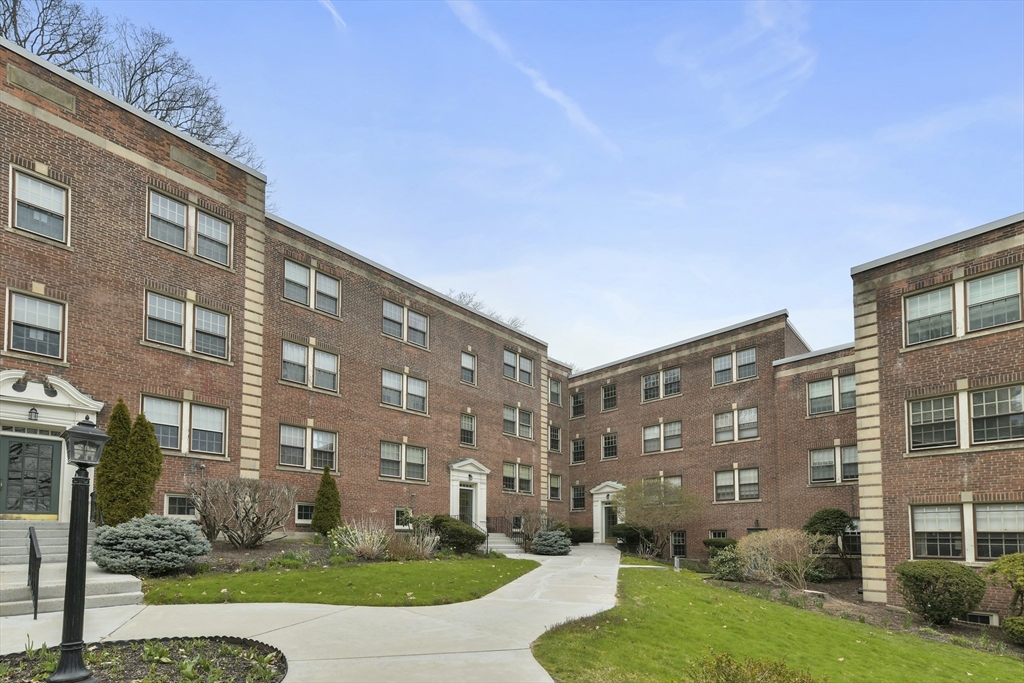 1490 Beacon Street, Unit 1A Brookline, MA 02446 - Photo 14 of 15 a view of a building with a yard