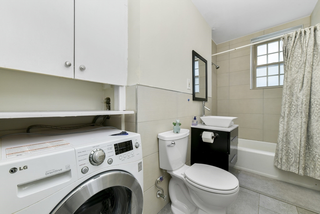 1490 Beacon Street, Unit 1A Brookline, MA 02446 - Photo 4 of 15 a bathroom with a sink a toilet and a vanity