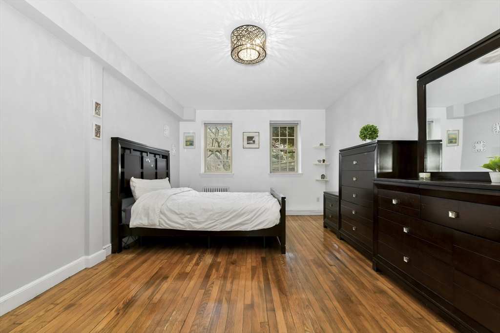 1490 Beacon Street, Unit 1A Brookline, MA 02446 - Photo 5 of 15 a bedroom with a bed and a television