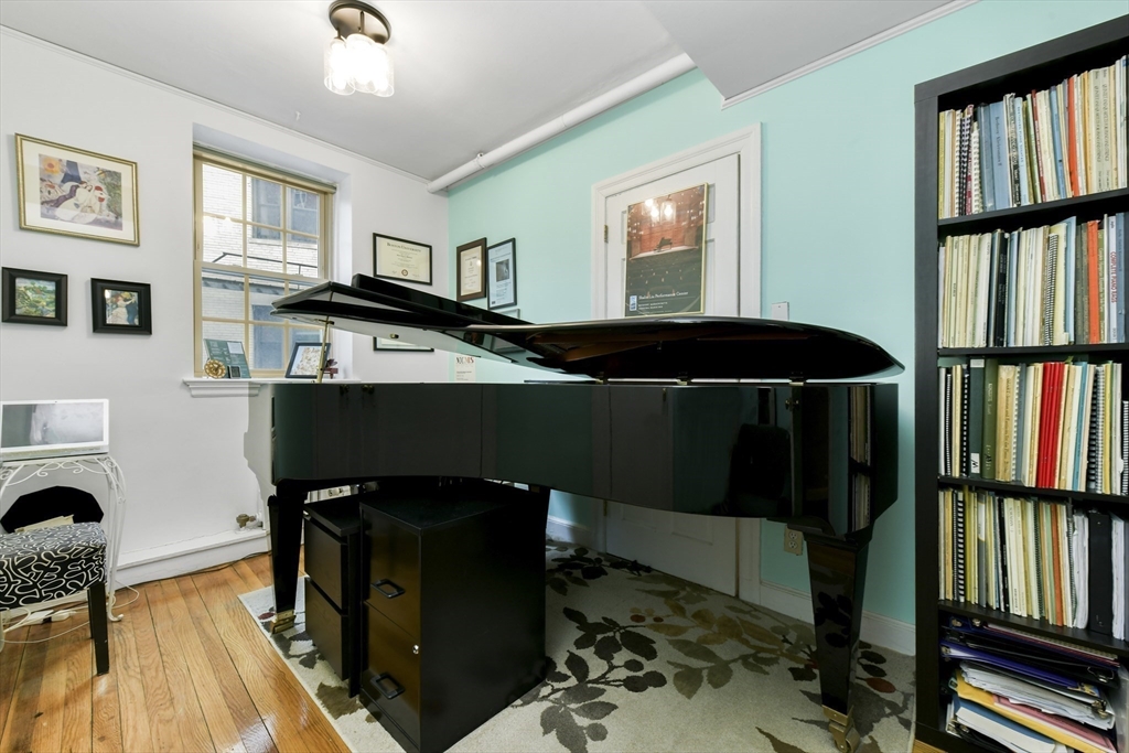 1490 Beacon Street, Unit 1A Brookline, MA 02446 - Photo 6 of 15 a living room with fish tank and a bookshelf