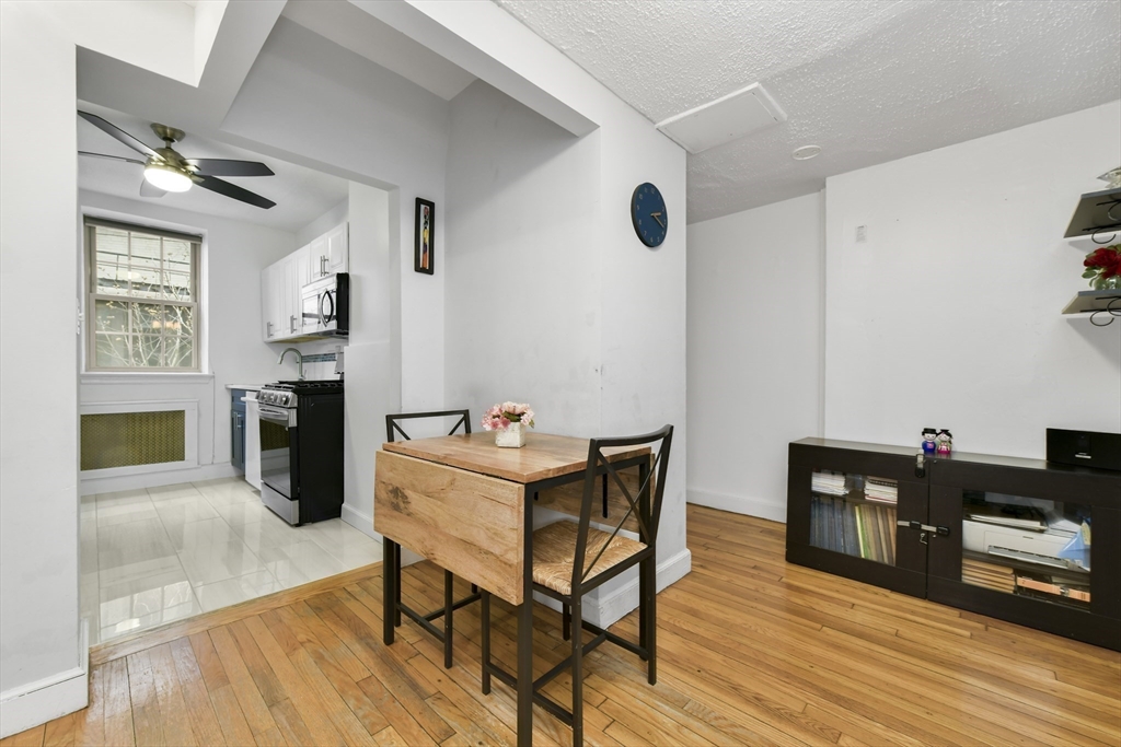1490 Beacon Street, Unit 1A Brookline, MA 02446 - Photo 7 of 15 a living room with furniture and a wooden floor