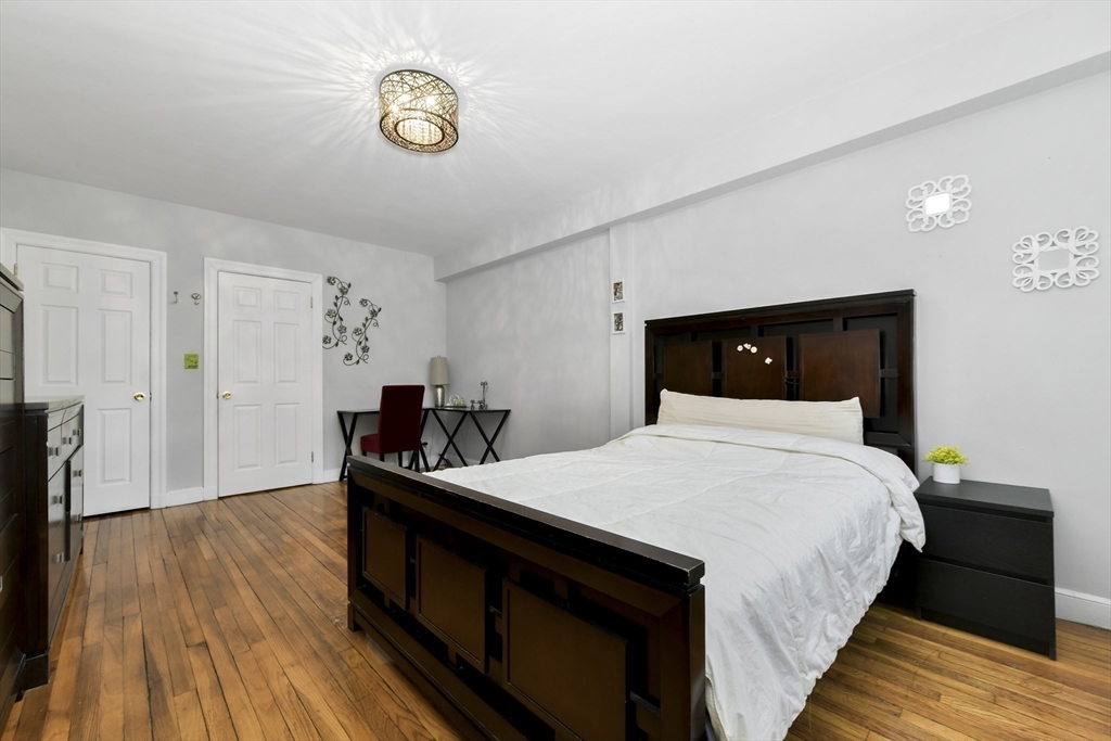 1490 Beacon Street, Unit 1A Brookline, MA 02446 - Photo 8 of 15 a bedroom with a bed and a table