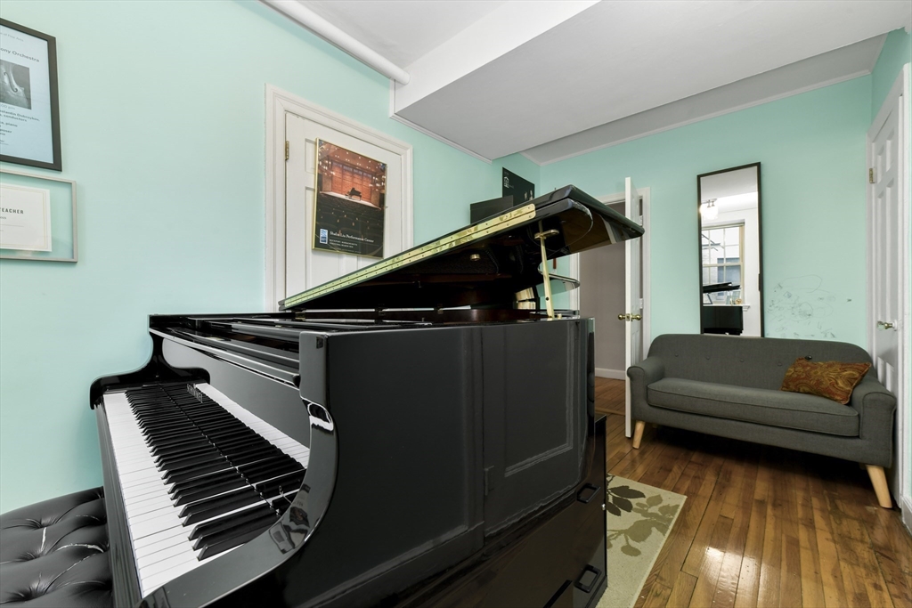 1490 Beacon Street, Unit 1A Brookline, MA 02446 - Photo 9 of 15 a living room with furniture and a piano
