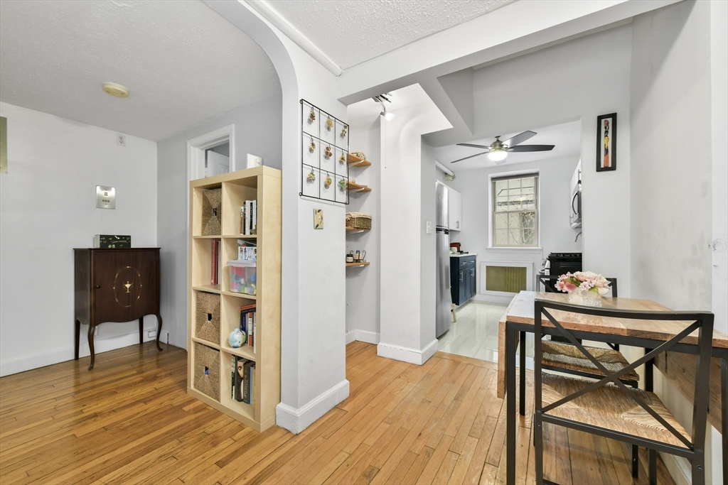 1490 Beacon Street, Unit 1A Brookline, MA 02446 - Photo 10 of 15 a dining room with furniture and wooden floor