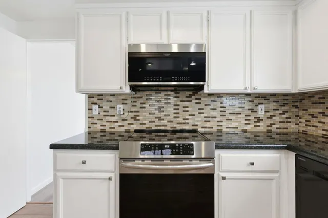 a kitchen with a stove and a microwave