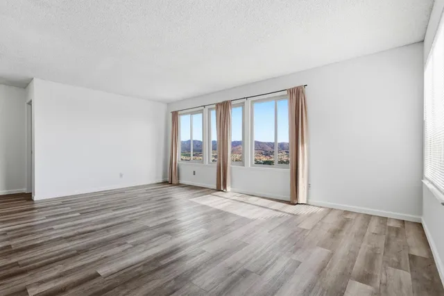 a view of an empty room with glass door