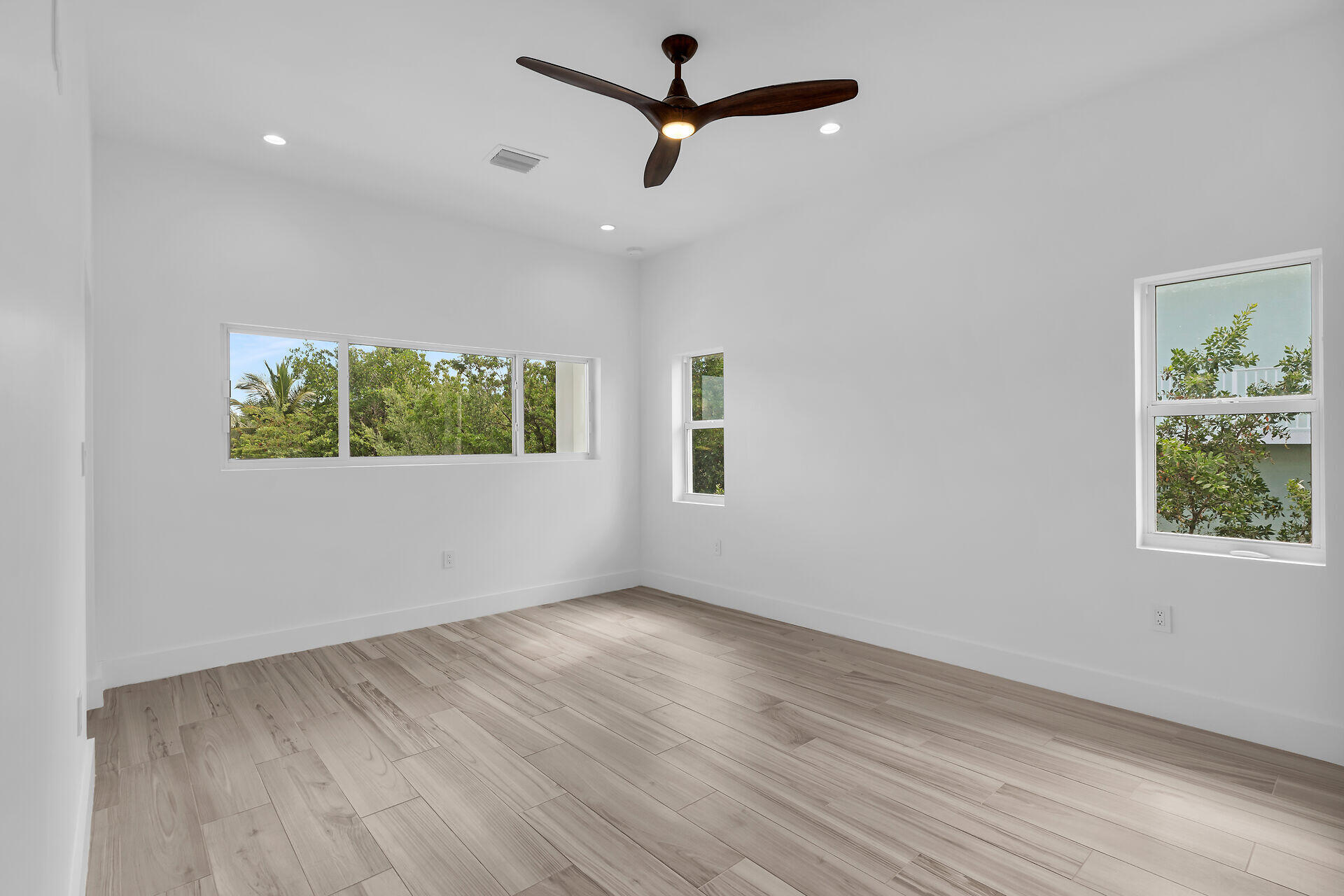1508 Shaw Drive Key Largo, FL 33037 - Photo 22 of 68 an empty room with wooden floor ceiling fan and windows