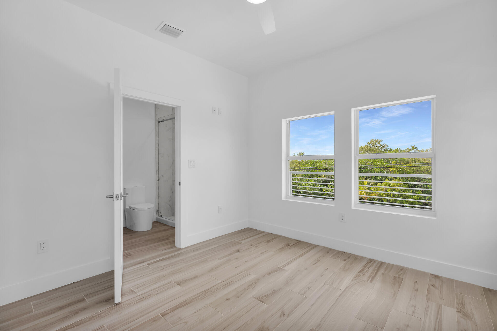 1508 Shaw Drive Key Largo, FL 33037 - Photo 38 of 68 a view of an empty room with wooden floor and a window