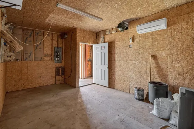 a view of a hallway with a room and front door