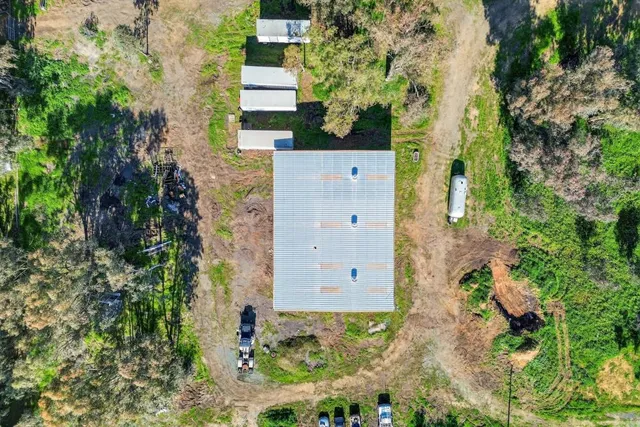 an aerial view of a house with a yard