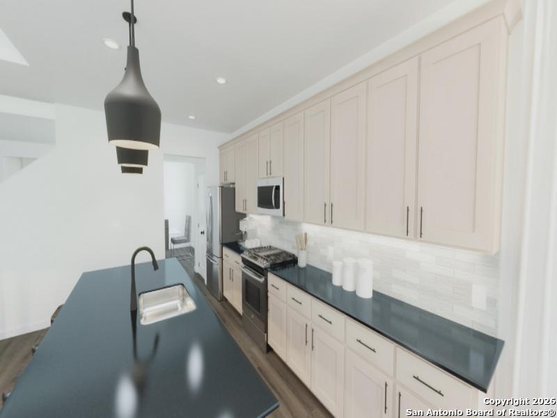 129 Yale Street Seguin, TX 78155 - Photo 5 of 45 a kitchen with granite countertop a sink and a stove top oven