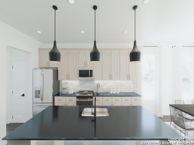 129 Yale Street Seguin, TX 78155 - Photo 6 of 45 a kitchen with kitchen island a counter top space appliances and a view of living room