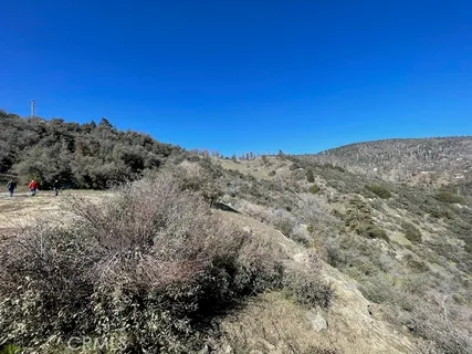 a view of a large building with mountains in the background