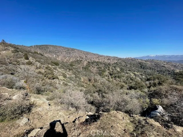 a view of a large building with mountains in the background