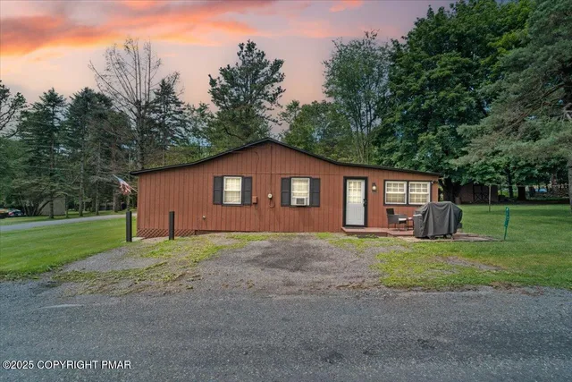 a house with huge green field in front of it