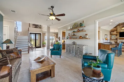 a living room with furniture and kitchen view
