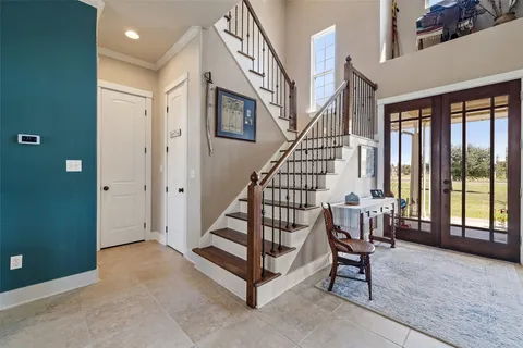 a view of an entryway with workspace and livingroom view