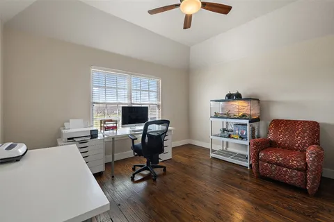 a view of a workspace with furniture and a window