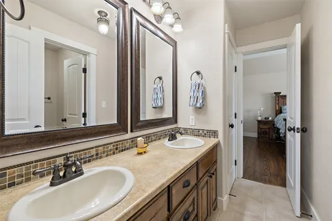 a en suite bathroom with a double vanity sink and mirror