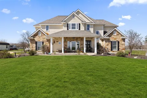 a view of a lobby with a chair and potted plants