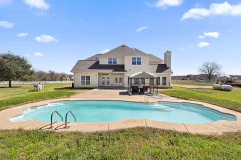 a swimming pool with outdoor seating and yard